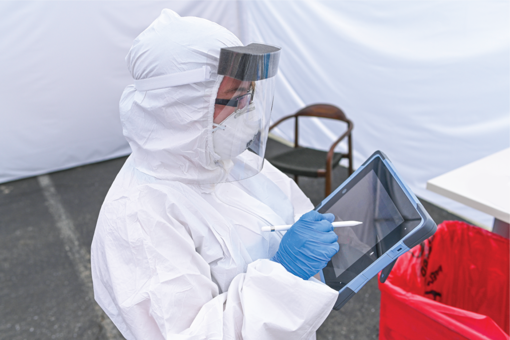 StemExpress Medical Assistant utilizing a tablet to consent a patient during a COVID-19 drive through testing event early May 2020