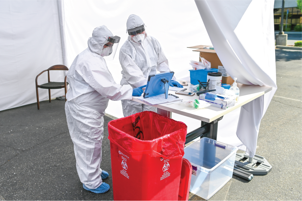 StemExpress Medical Assistants reviewing patient consent information during a COVID-19 drive through testing event early May 2020